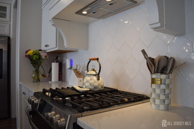 3504 Charleston Dr, Monroe, NJ 08831 - kitchen featuring stainless steel gas stove, range hood, tasteful backsplash, and light countertops