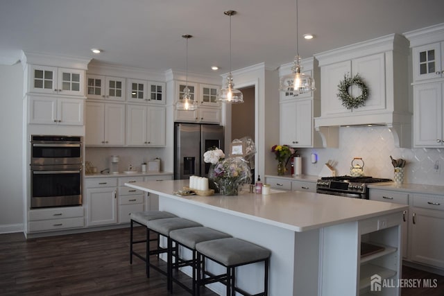 3504 Charleston Dr, Monroe, NJ 08831 - kitchen featuring stainless steel appliances, a kitchen island, light countertops, tasteful backsplash, and white cabinetry