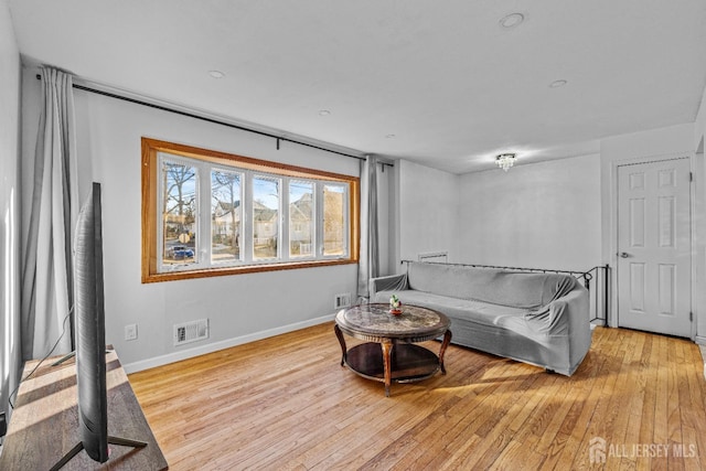 living room with light hardwood / wood-style flooring