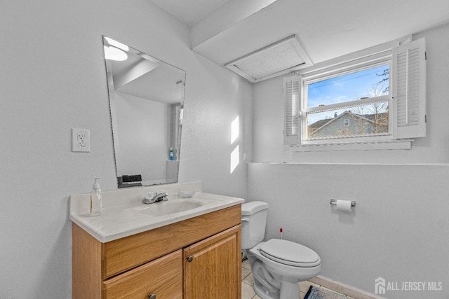 bathroom featuring toilet, vanity, and tile patterned floors