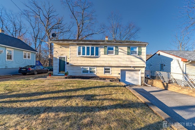 view of front of home featuring a garage and a front lawn