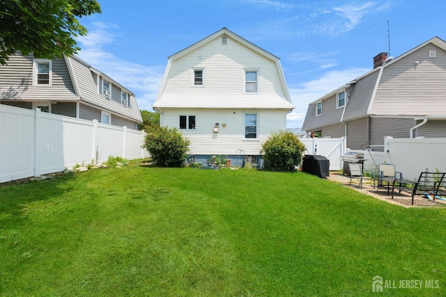 336 S Main St, Milltown, NJ 08850 - back of property with a fenced backyard, a gambrel roof, and a patio