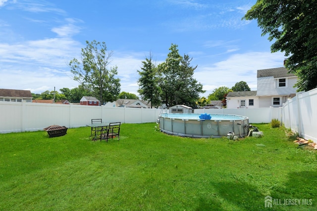 336 S Main St, Milltown, NJ 08850 - fenced backyard with an outdoor fire pit