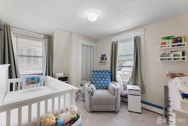 336 S Main St, Milltown, NJ 08850 - bedroom featuring baseboard heating, a textured ceiling, light carpet, and a closet