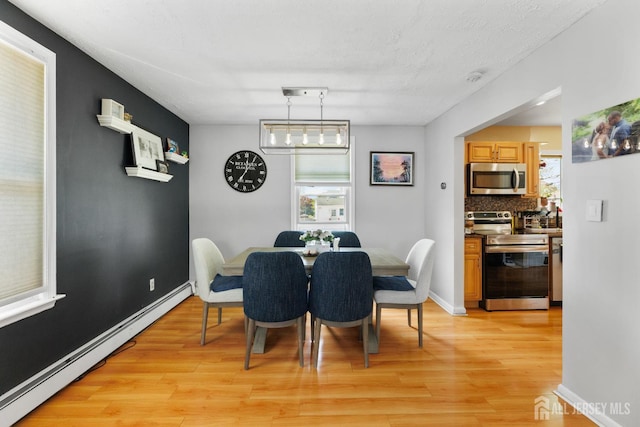 336 S Main St, Milltown, NJ 08850 - dining room with a baseboard heating unit, light wood-type flooring, and plenty of natural light