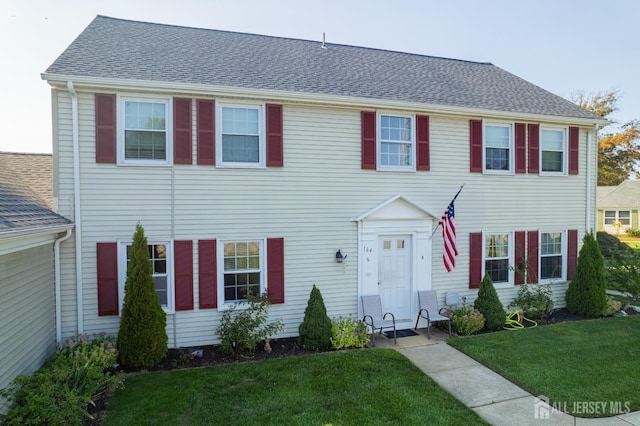 colonial home with a front yard