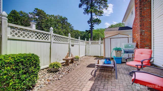 3 Feathertree Ct, Howell, NJ 07731 - fenced backyard with a patio area and a storage unit