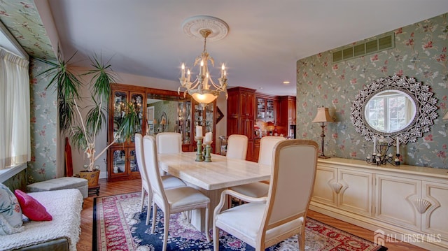 3 Feathertree Ct, Howell, NJ 07731 - dining room with wallpapered walls, a chandelier, and light wood-style flooring