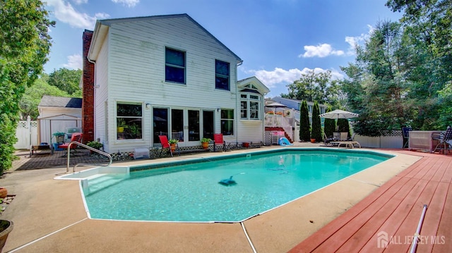 3 Feathertree Ct, Howell, NJ 07731 - view of swimming pool featuring a storage unit, a wooden deck, a patio, and french doors