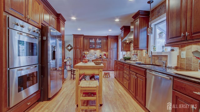 3 Feathertree Ct, Howell, NJ 07731 - kitchen with stainless steel appliances, wall chimney range hood, light wood-style flooring, backsplash, and recessed lighting