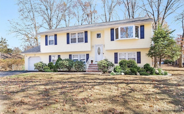 bi-level home featuring a garage and driveway