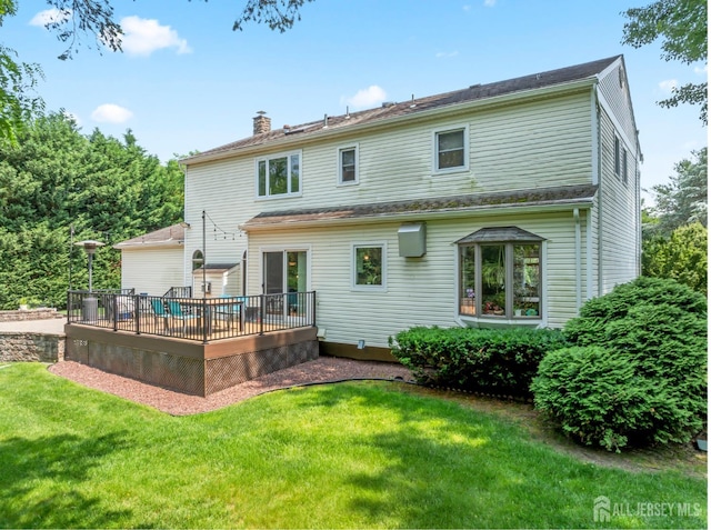 6 Schindler Ct, East Brunswick, NJ 08816 - back of property featuring a wooden deck, a chimney, and a yard
