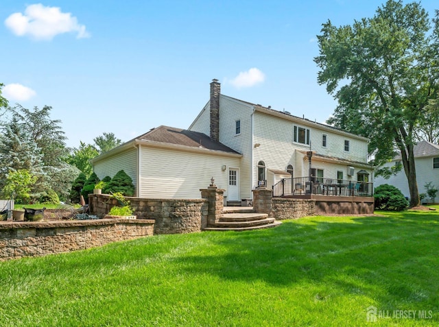 6 Schindler Ct, East Brunswick, NJ 08816 - back of property with a yard, a deck, and a chimney