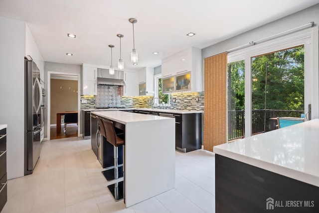 6 Schindler Ct, East Brunswick, NJ 08816 - kitchen with light countertops, backsplash, a center island, white cabinetry, and recessed lighting