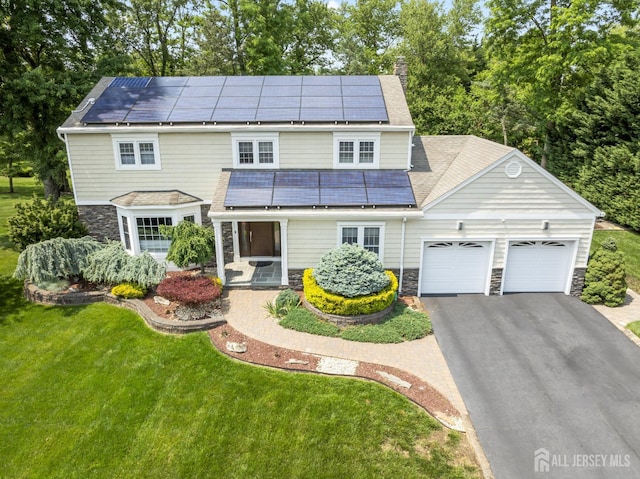 6 Schindler Ct, East Brunswick, NJ 08816 - traditional home featuring solar panels, an attached garage, stone siding, and a front yard