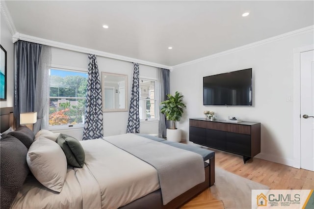 bedroom with multiple windows, light wood-style flooring, and crown molding