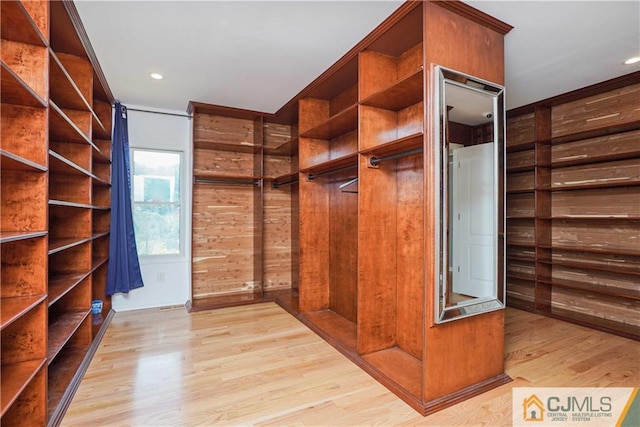 spacious closet with light wood-style floors