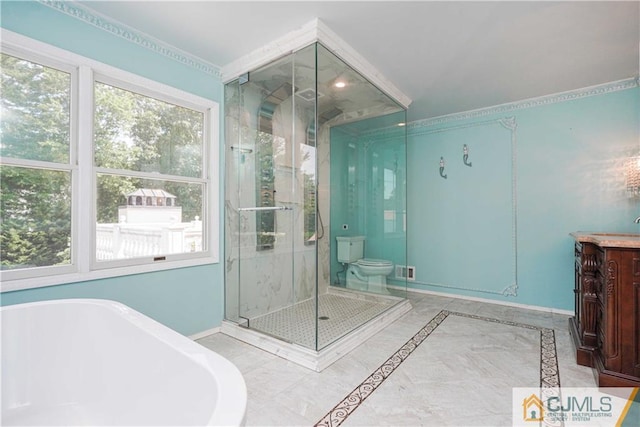 bathroom with a stall shower, baseboards, and a freestanding tub