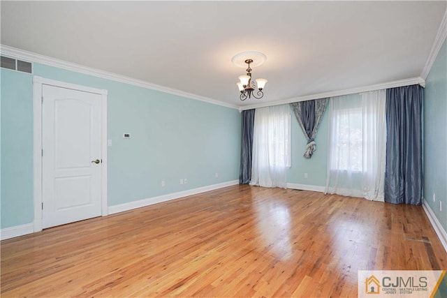 unfurnished room featuring light wood-style flooring, a notable chandelier, visible vents, baseboards, and crown molding