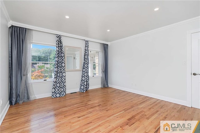 spare room with light wood-style floors, baseboards, ornamental molding, and recessed lighting