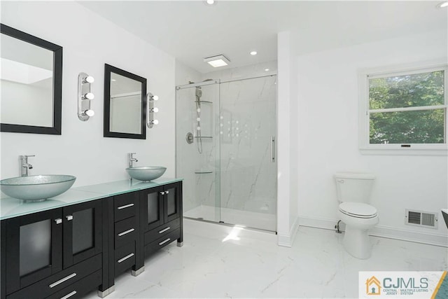 bathroom featuring marble finish floor, visible vents, a sink, and a marble finish shower