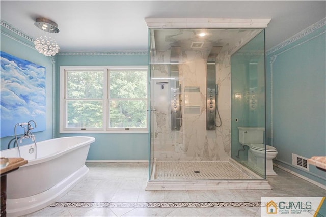 bathroom featuring visible vents, baseboards, a freestanding bath, tile patterned floors, and a stall shower