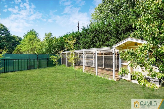 view of yard featuring an outdoor structure, a fenced backyard, and exterior structure