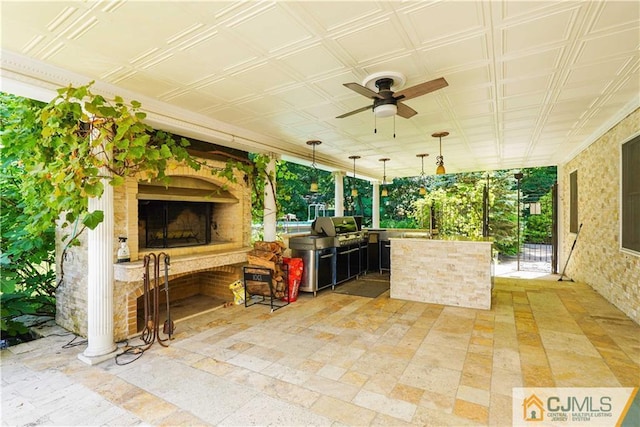 view of patio / terrace with ceiling fan, exterior fireplace, and area for grilling