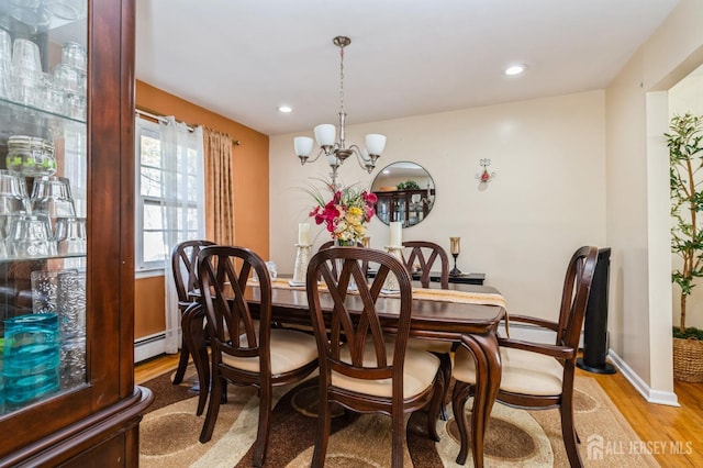 dining room with baseboards, a chandelier, light wood-type flooring, a baseboard heating unit, and recessed lighting