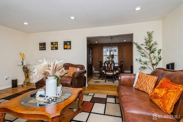 living area featuring wood finished floors, an inviting chandelier, and recessed lighting