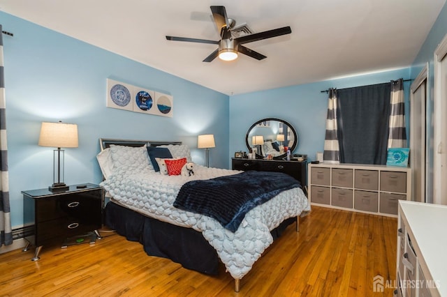 bedroom with ceiling fan and hardwood / wood-style floors