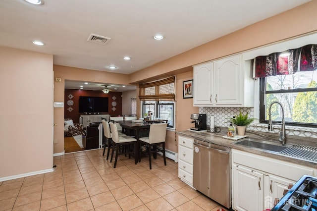 kitchen featuring tasteful backsplash, white cabinetry, a sink, ceiling fan, and dishwasher