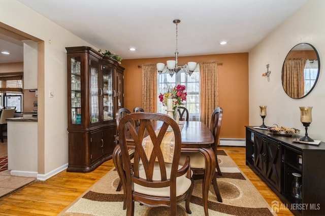 dining area featuring baseboards, baseboard heating, light wood-style floors, a notable chandelier, and recessed lighting