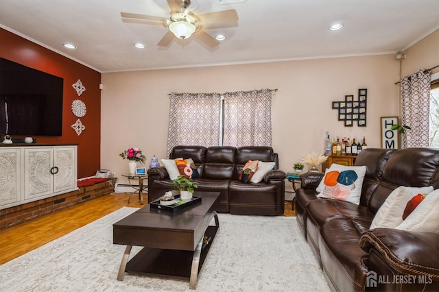 living area featuring crown molding, wood finished floors, recessed lighting, a ceiling fan, and a baseboard heating unit