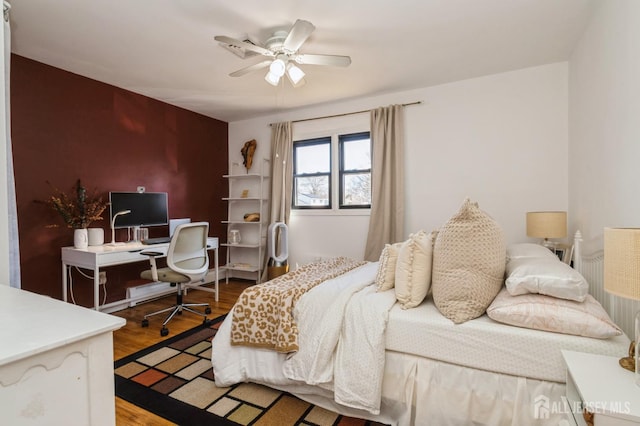 bedroom with ceiling fan and wood finished floors