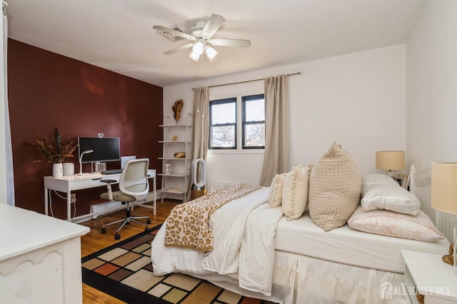 bedroom with wood finished floors and ceiling fan