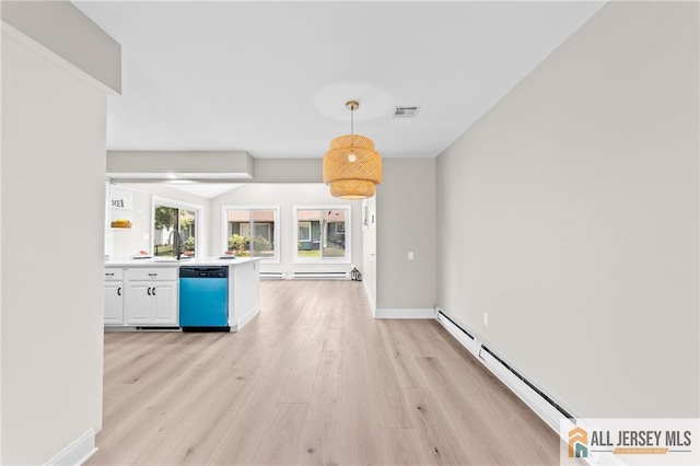 442 Dahlia Plz Unit 442A, Monroe, NJ 08831 - unfurnished living room featuring light wood finished floors and a baseboard radiator
