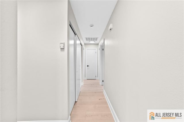 442 Dahlia Plz Unit 442A, Monroe, NJ 08831 - hallway with light wood-style floors and baseboards