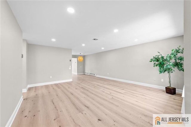 442 Dahlia Plz Unit 442A, Monroe, NJ 08831 - unfurnished room featuring light wood-style floors, a baseboard heating unit, and recessed lighting