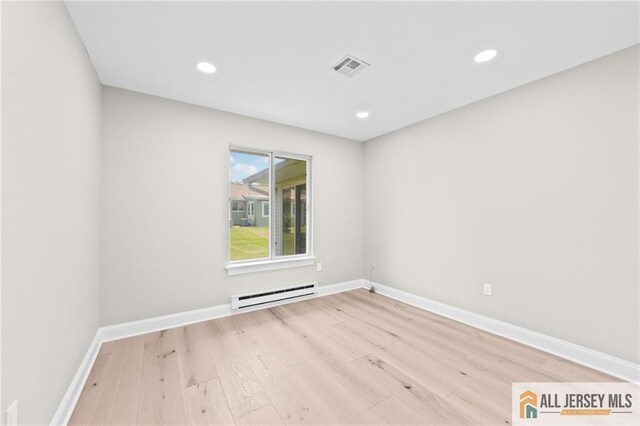 442 Dahlia Plz Unit 442A, Monroe, NJ 08831 - empty room with a baseboard heating unit, wood finished floors, and recessed lighting