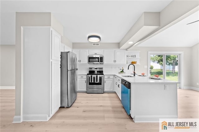 442 Dahlia Plz Unit 442A, Monroe, NJ 08831 - kitchen featuring appliances with stainless steel finishes, light wood-style flooring, and white cabinets