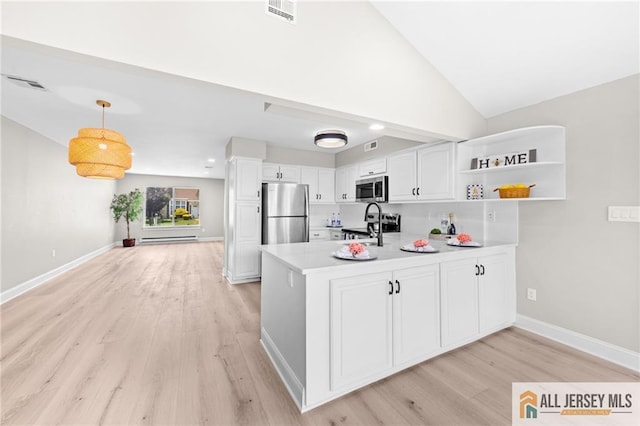 442 Dahlia Plz Unit 442A, Monroe, NJ 08831 - kitchen with stainless steel appliances, light wood-type flooring, a peninsula, white cabinets, and lofted ceiling