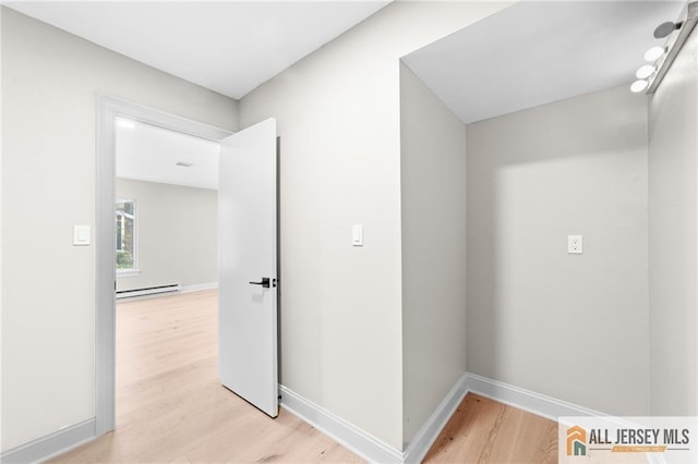 442 Dahlia Plz Unit 442A, Monroe, NJ 08831 - hallway featuring a baseboard heating unit and light wood finished floors