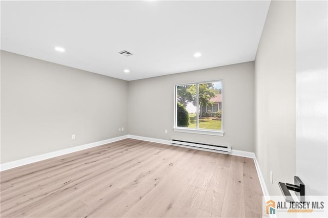 442 Dahlia Plz Unit 442A, Monroe, NJ 08831 - empty room featuring baseboard heating, wood finished floors, and recessed lighting