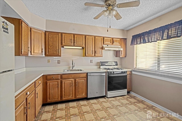 kitchen with sink, white appliances, a textured ceiling, and ceiling fan