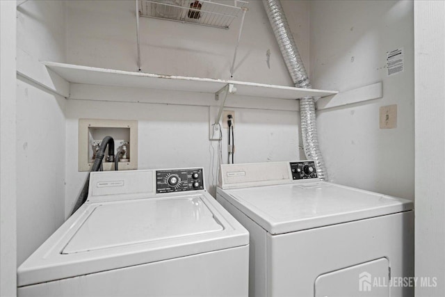 washroom with separate washer and dryer