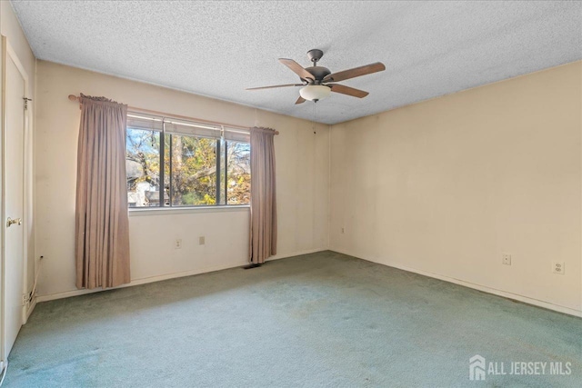 spare room with a textured ceiling, ceiling fan, and carpet flooring