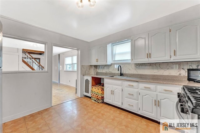 224 2nd St, South Amboy, NJ 08879 - kitchen with gas range, plenty of natural light, tasteful backsplash, and light countertops