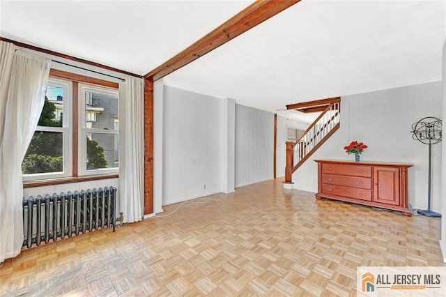 224 2nd St, South Amboy, NJ 08879 - bonus room with radiator heating unit, stairs, and wooden walls