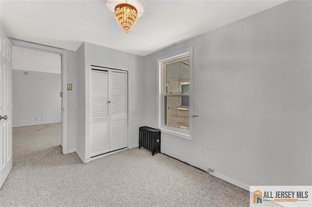 224 2nd St, South Amboy, NJ 08879 - unfurnished bedroom with radiator, carpet, a closet, and baseboards
